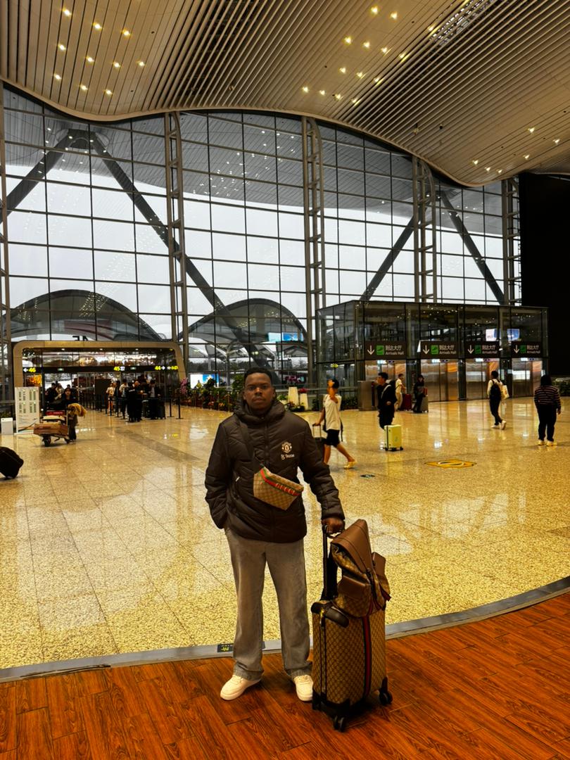 Student travelling with luggage through a modern terminal